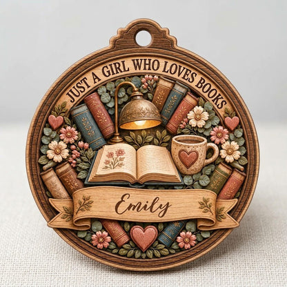 Round wood ornament with faux carved open book, glowing lamp, heart mug, stacked books, flowers, and a personalized name