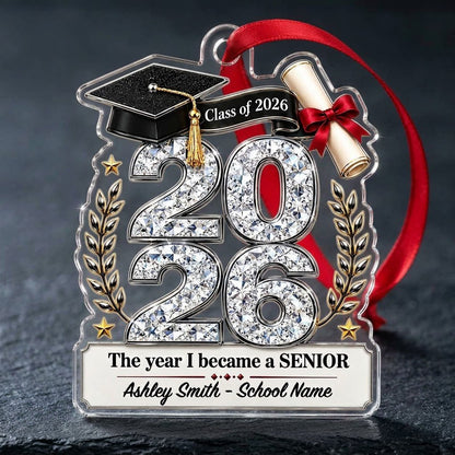 Custom-cut clear acrylic ornament shaped like a graduation cap with Class of 2026, diploma, laurels, and name plaque.
