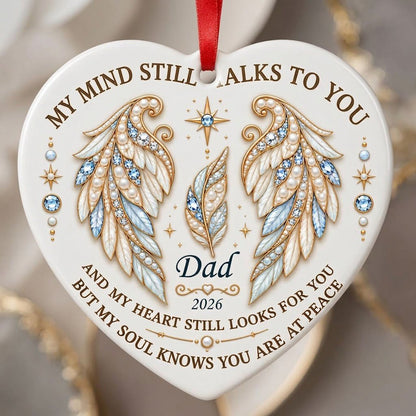 White heart ceramic ornament with jeweled angel wings, blue gems, gold scrollwork, personalized name and year.