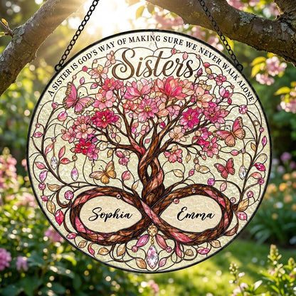 Round stained glass suncatcher with tree of life, pink blossoms, butterflies, and Sisters text with two names.