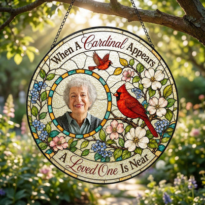 Round faux stained-glass suncatcher with two red cardinals, dogwood flowers, and a left-side circular photo frame.