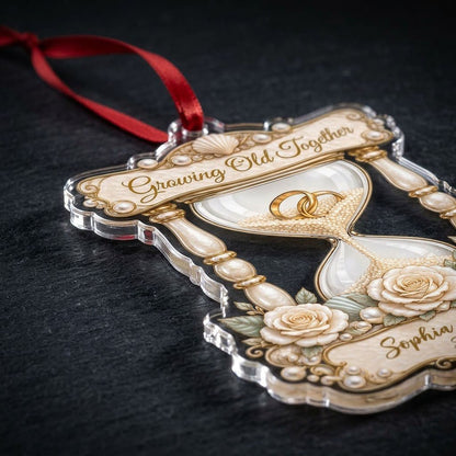 Acrylic hourglass ornament with gold rings, roses, seashells, pearls, and Growing Old Together text.