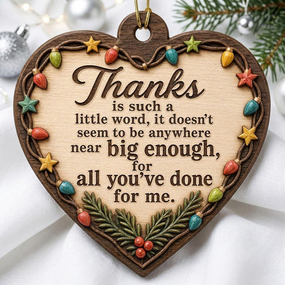 Heart-shaped wood ornament with a lights-and-stars border, pine sprigs with red berries, and a gratitude quote.