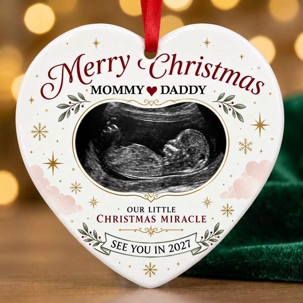 Heart ceramic ornament with ultrasound photo, gold starbursts, green leaves with red berries, and a bottom banner.