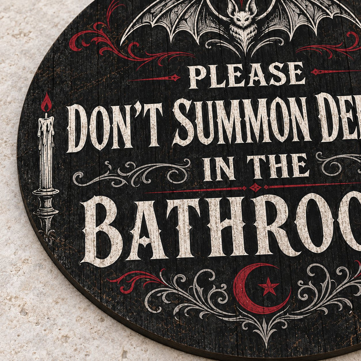 Round wooden sign with bat, filigree, candles and a crescent moon reading PLEASE DON'T SUMMON DEMONS IN THE BATHROOM.
