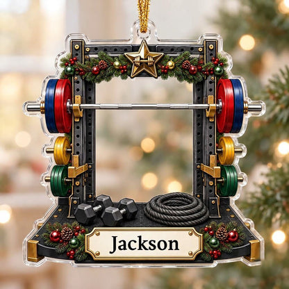 A squat rack-shaped acrylic ornament with garland, barbell, dumbbells, and a photo cutout above a name plaque.