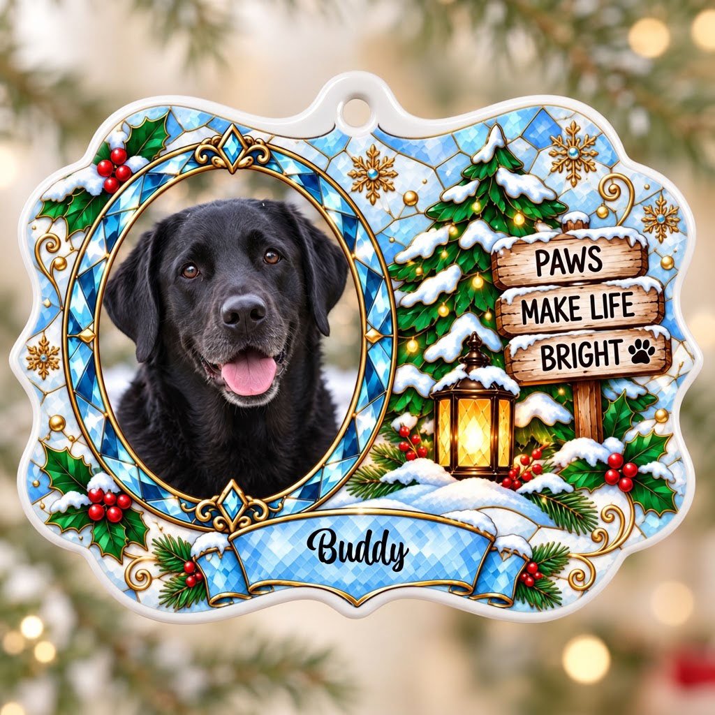 Scalloped ceramic medallion ornament with dog photo, blue stained glass frame, lantern, and Christmas tree in snow.