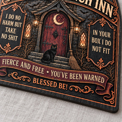 Arch wooden sign with a witch's cottage, bats, moon phases, red crescent door, broom, and a black cat on the steps.