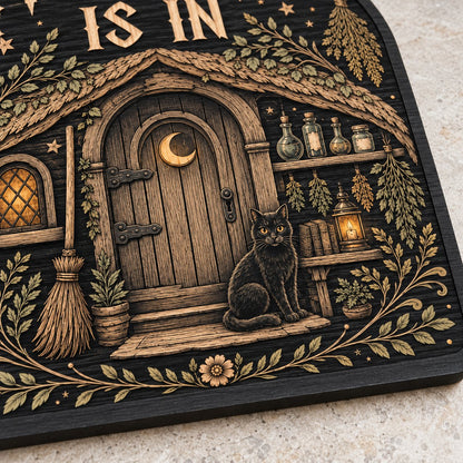 Arch wood sign with "THE WITCH IS IN", witch cottage, black cat, broom, herbs and lantern details.