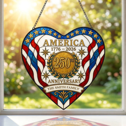 Heart suncatcher with red, white and blue stripes, gold medallion, laurel wreath, and 'America 1776–2026' text.