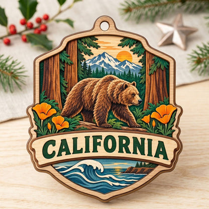 Shield-shaped wood ornament reading CALIFORNIA with bear on log, poppies, redwoods, mountains, and ocean waves.