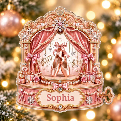Pink ballet music box ornament with pointe shoes, velvet curtains, pearls, snowflakes, and a name plaque.