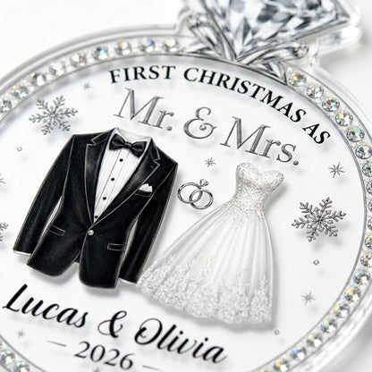 Clear acrylic diamond-ring ornament with tuxedo, lace gown, silver rings and 'First Christmas as Mr. & Mrs.' text.