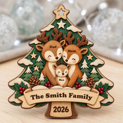 Tree-shaped wood ornament with a deer family, star topper, holly, pinecones, and personalized names and year.