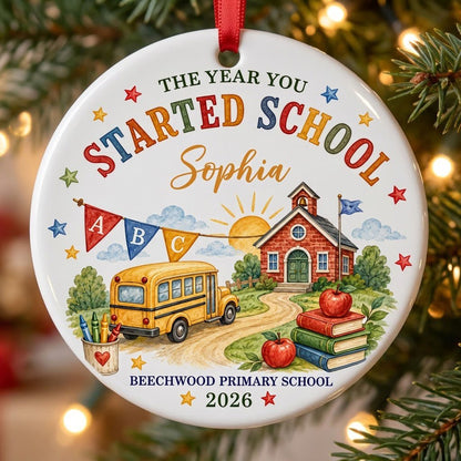 Round ceramic ornament with watercolor school bus, red brick schoolhouse, ABC bunting, books, apples, and colorful stars