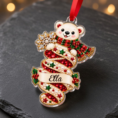 A custom-cut clear acrylic ornament shows a polar bear and Mrs. Claus in a jeweled spiral with a name banner and red rib