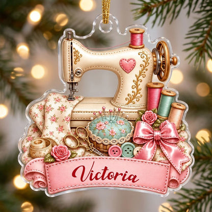 Custom-cut acrylic ornament with vintage cream sewing machine, pink banner, roses, thread spools and scissors.