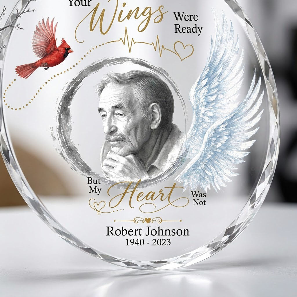 Round glass ornament with a sketch portrait frame, blue angel wing, red cardinal and 'Your Wings Were Ready' memorial te