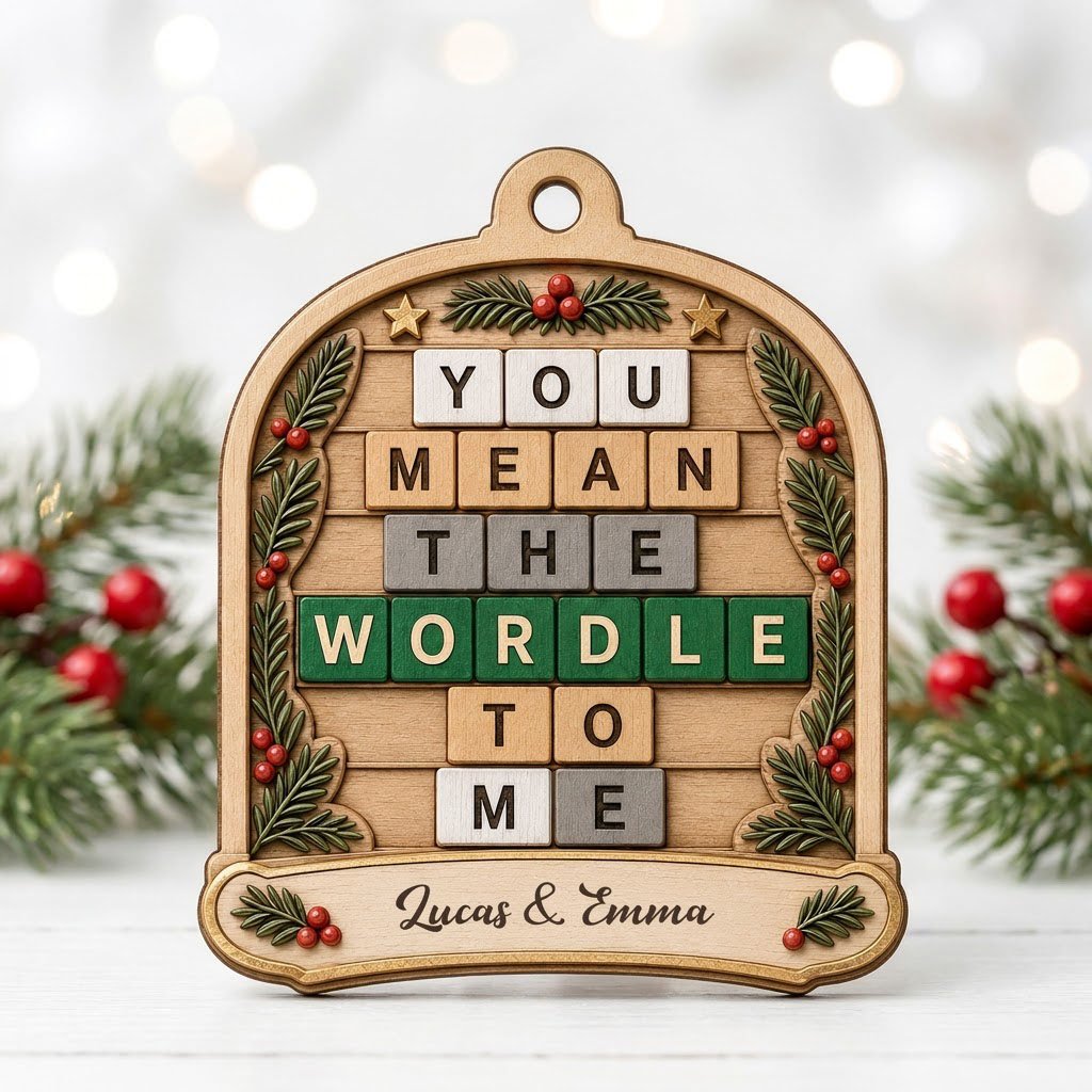 Arch wood ornament with “You Mean The Wordle To Me” letter tiles, evergreen sprigs with red berries, gold stars, and cou