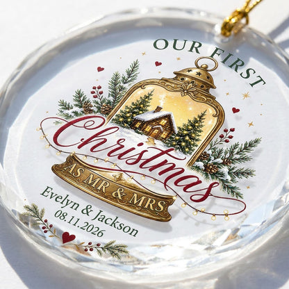 Round glass ornament with gold lantern, cozy cabin, pine branches, holly berries, and Our First Christmas as Mr & Mrs.