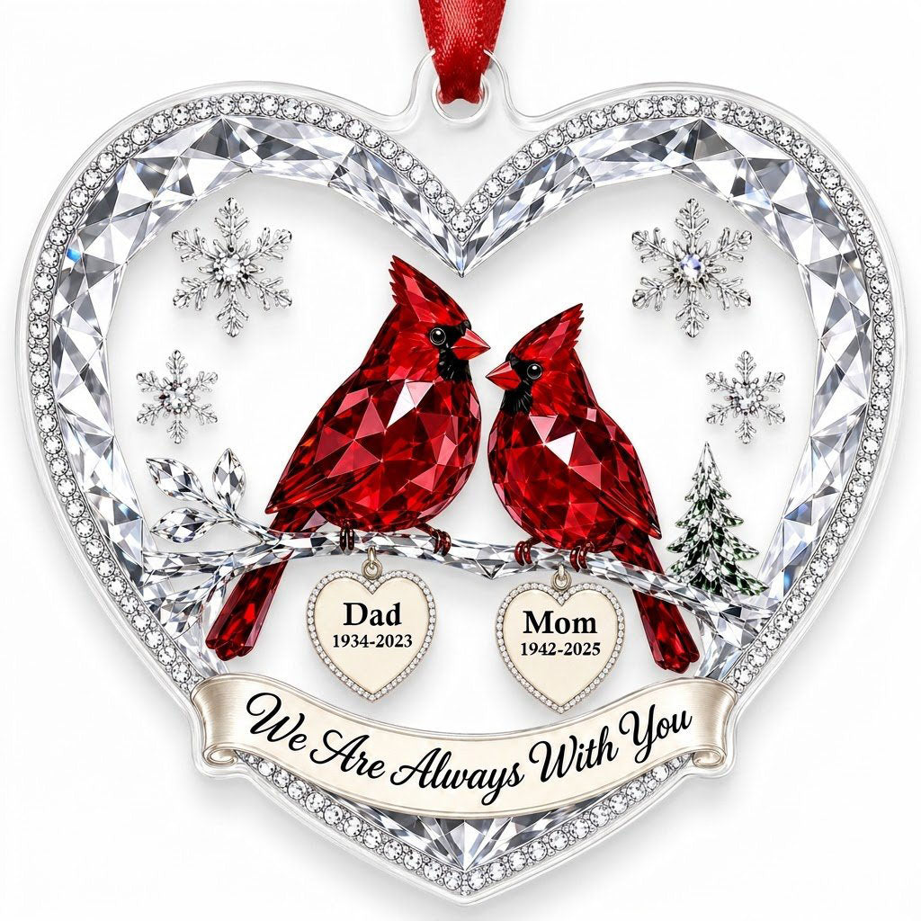 Heart ornament with two red crystal-style cardinals, snowflakes, a ribbon banner, and two dangling name-date heart charm