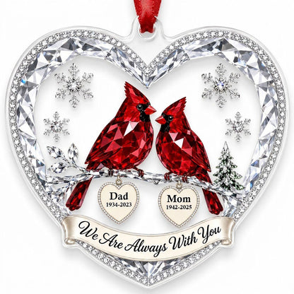 Heart ornament with two red crystal-style cardinals, snowflakes, a ribbon banner, and two dangling name-date heart charm