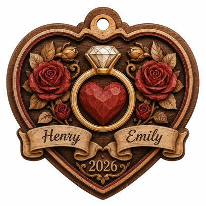 Heart-shaped wood ornament with a gold ring, red heart, red roses, and names Henry and Emily with year 2026.