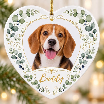 Heart ceramic ornament with a pet photo framed by gold heart scrollwork and eucalyptus with dark blue berries.