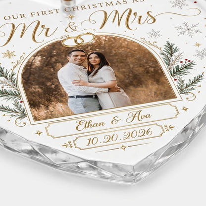 Heart-shaped glass ornament with photo, gold wedding rings, pine branches, snowflakes, and Mr & Mrs text.