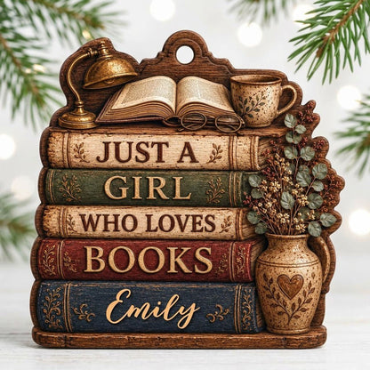 Bookshelf-shaped wood ornament with lamp, open book, teacup, vase, and Just a Girl Who Loves Books text.