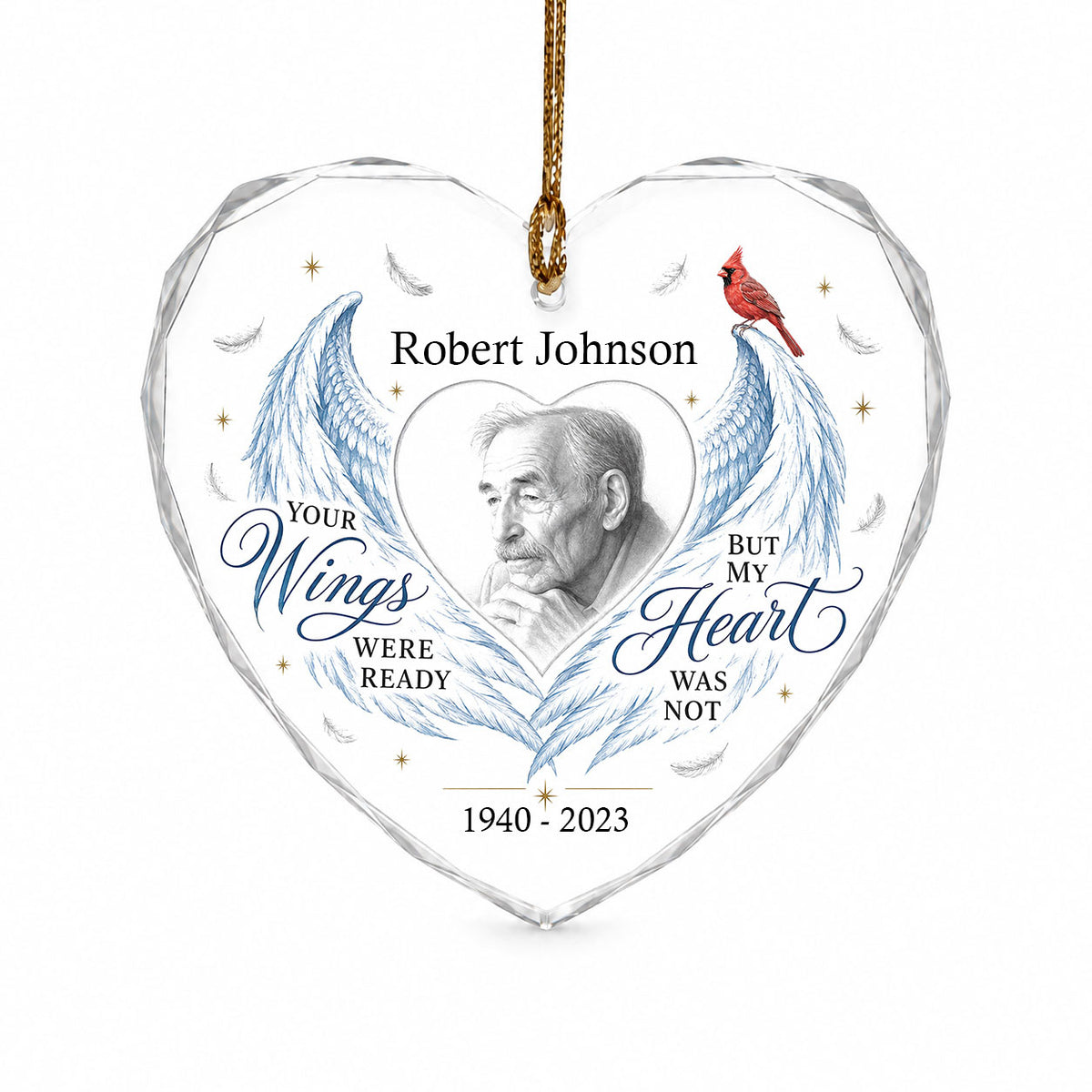 Heart-shaped glass ornament with blue angel wings, red cardinal, and a memorial quote with name and years.