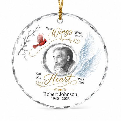 Round glass ornament with a sketch portrait frame, blue angel wing, red cardinal and 'Your Wings Were Ready' memorial te
