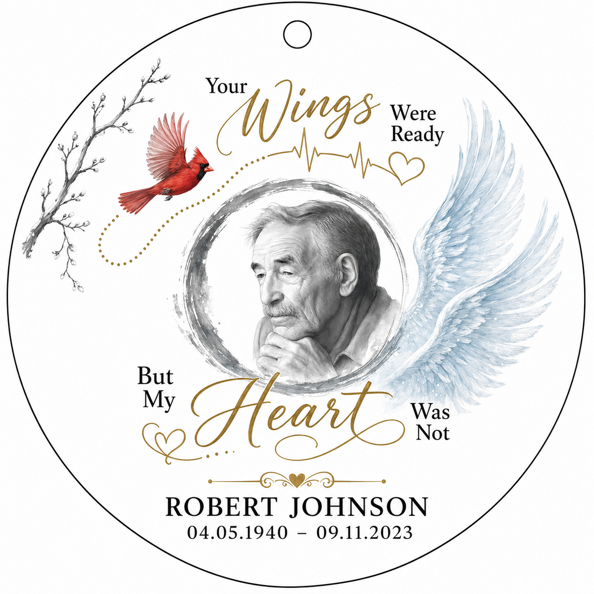 Round glass ornament with a sketch portrait frame, blue angel wing, red cardinal and 'Your Wings Were Ready' memorial te