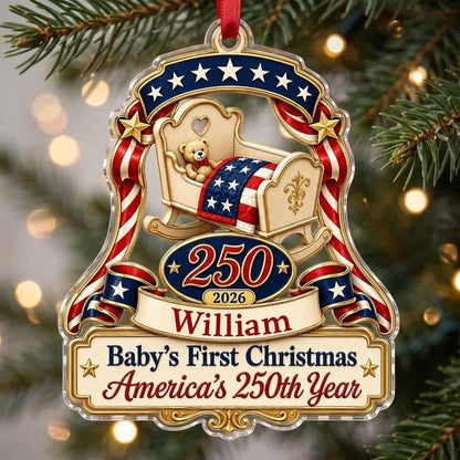 Acrylic ornament with baby crib, teddy bear, patriotic ribbon, and 'Baby's First Christmas', personalized with name and 