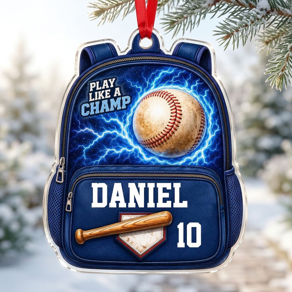 Backpack-shaped acrylic ornament with a baseball, blue lightning, a bat on home plate, and PLAY LIKE A CHAMP text.