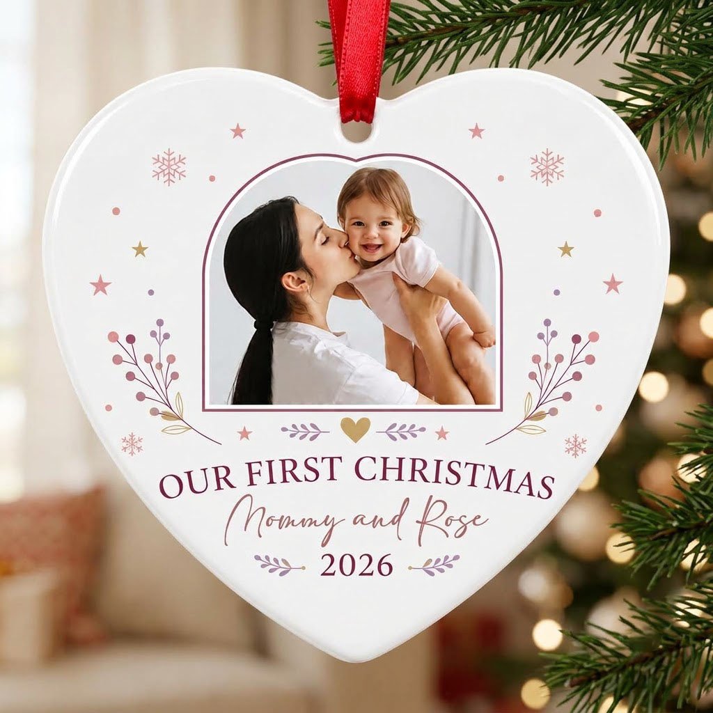 Heart ceramic ornament with “OUR FIRST CHRISTMAS”, arch photo frame, stars, snowflakes, berry sprigs, leafy flourishes, 