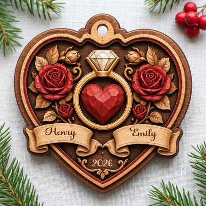 Heart-shaped wood ornament with a gold ring, red heart, red roses, and names Henry and Emily with year 2026.