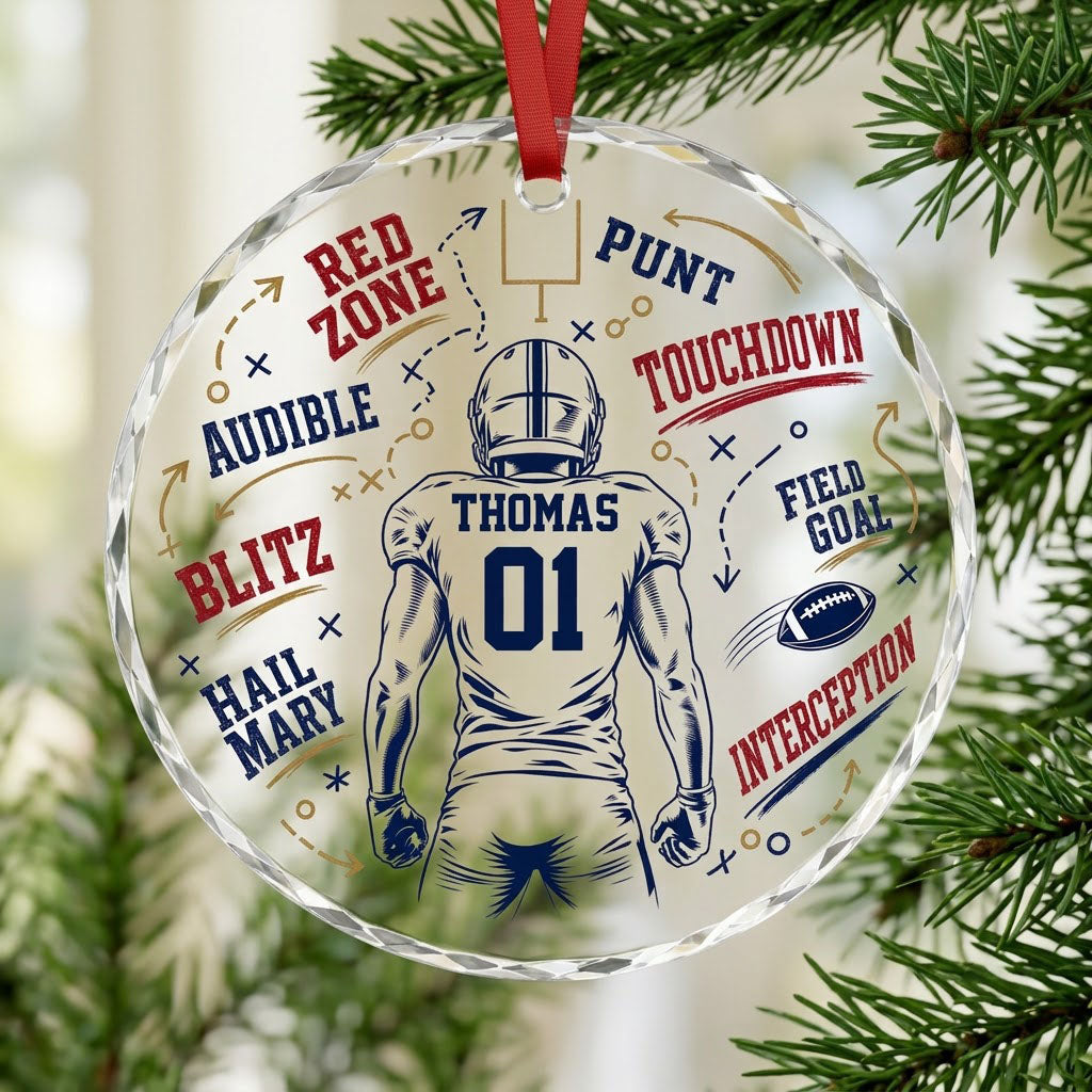 Round faceted glass ornament with football player back view, goalpost, football, and play diagrams in navy, dark red, an