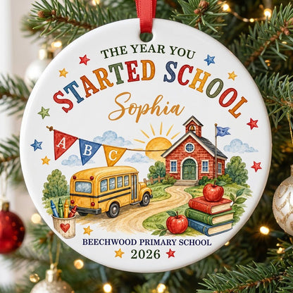 Round ceramic ornament with watercolor school bus, red brick schoolhouse, ABC bunting, books, apples, and colorful stars