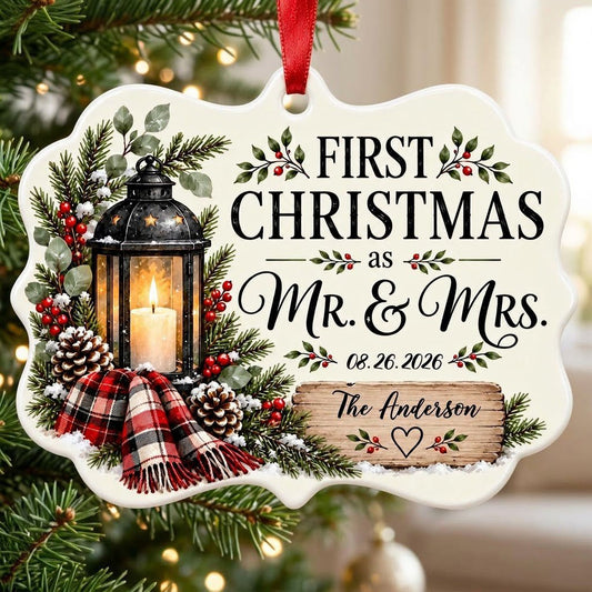 Medallion ceramic ornament with black lantern, pine, red berries, plaid scarf, and 'FIRST CHRISTMAS as MR. & MRS.' text.