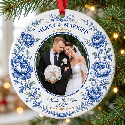 Round ceramic ornament with blue chinoiserie border, gold accents, and a circular wedding photo framed at center.