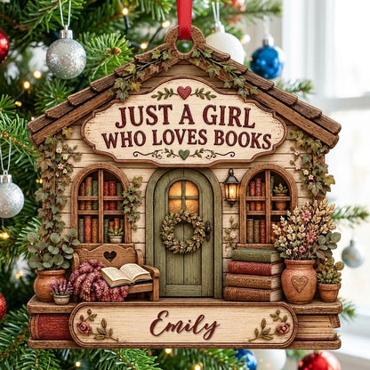 House-shaped wood ornament with 'JUST A GIRL WHO LOVES BOOKS', bookshelves, green door with wreath, and the name Emily.