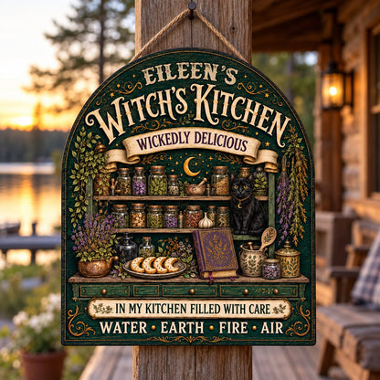 Arch wooden sign with black cat, apothecary jars, lavender, crescent moon and stars, and the text WITCH'S KITCHEN.