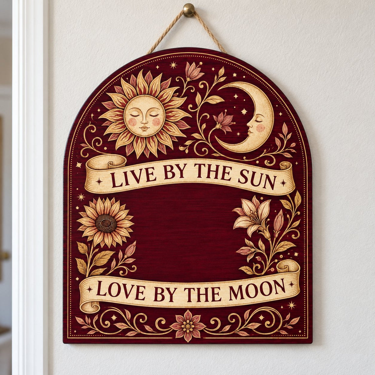 Arch sign with sleeping sun and moon, sunflower and lilies, banners reading Live by the Sun and Love by the Moon.