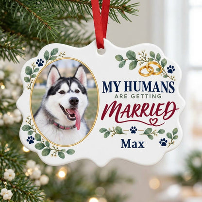 Scalloped medallion ornament with dog photo, eucalyptus, paw prints, and 'MY HUMANS ARE GETTING MARRIED' text.