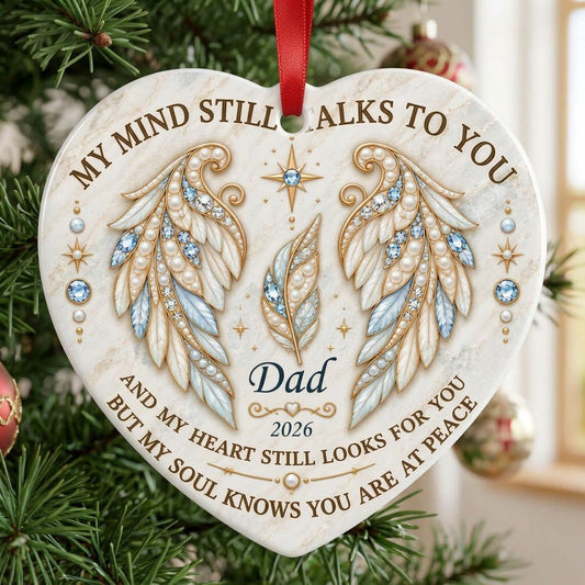 White heart ceramic ornament with jeweled angel wings, blue gems, gold scrollwork, personalized name and year.