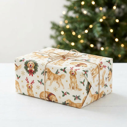 Cream wrapping paper with Golden Retriever dogs in antlers and scarves, wreaths, holly, snowflakes and stars.
