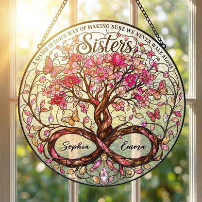 Round stained glass suncatcher with tree of life, pink blossoms, butterflies, and Sisters text with two names.