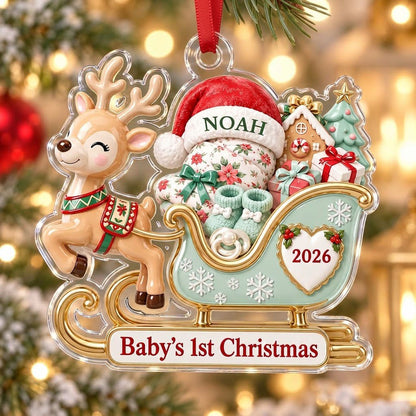 Acrylic ornament of a reindeer pulling a mint-green sleigh with a baby, gifts, and 'Baby's 1st Christmas' text.