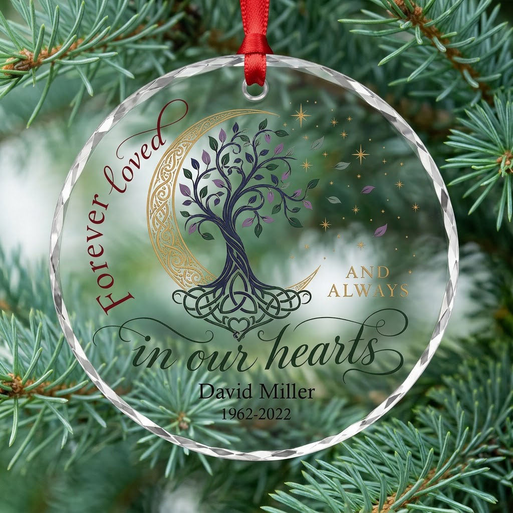 Round glass ornament with Celtic tree of life, gold crescent moon, stars, and phrase Forever loved in our hearts.